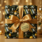 Elegant Christmas gift wrap with green ribbons and gold bow by Wrapped Studios.