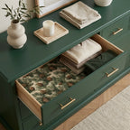 Rustic pinecone Christmas wrapping paper by Wrapped Studios lining an elegant green dresser drawer.