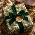 Rustic pinecone Christmas wrapping paper with green velvet bow, holiday gift wrap by Wrapped Studios.