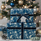 Elegant Christmas gift wrap: Blue floral wrapping paper with velvet ribbon and a "Joy to You" tag.