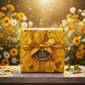 Golden floral wrapping paper with satin ribbon and "A Ray of Sunshine" tag, perfect for birthday gift wrap.