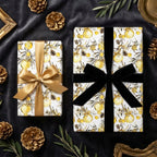 Elegant botanical Christmas wrapping paper with gold ornaments and velvet ribbons, by Wrapped Studios.