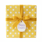 Yellow polka dot Easter gift wrap with a velvet ribbon and "Happy Easter" tag, perfect for spring holiday presents.
